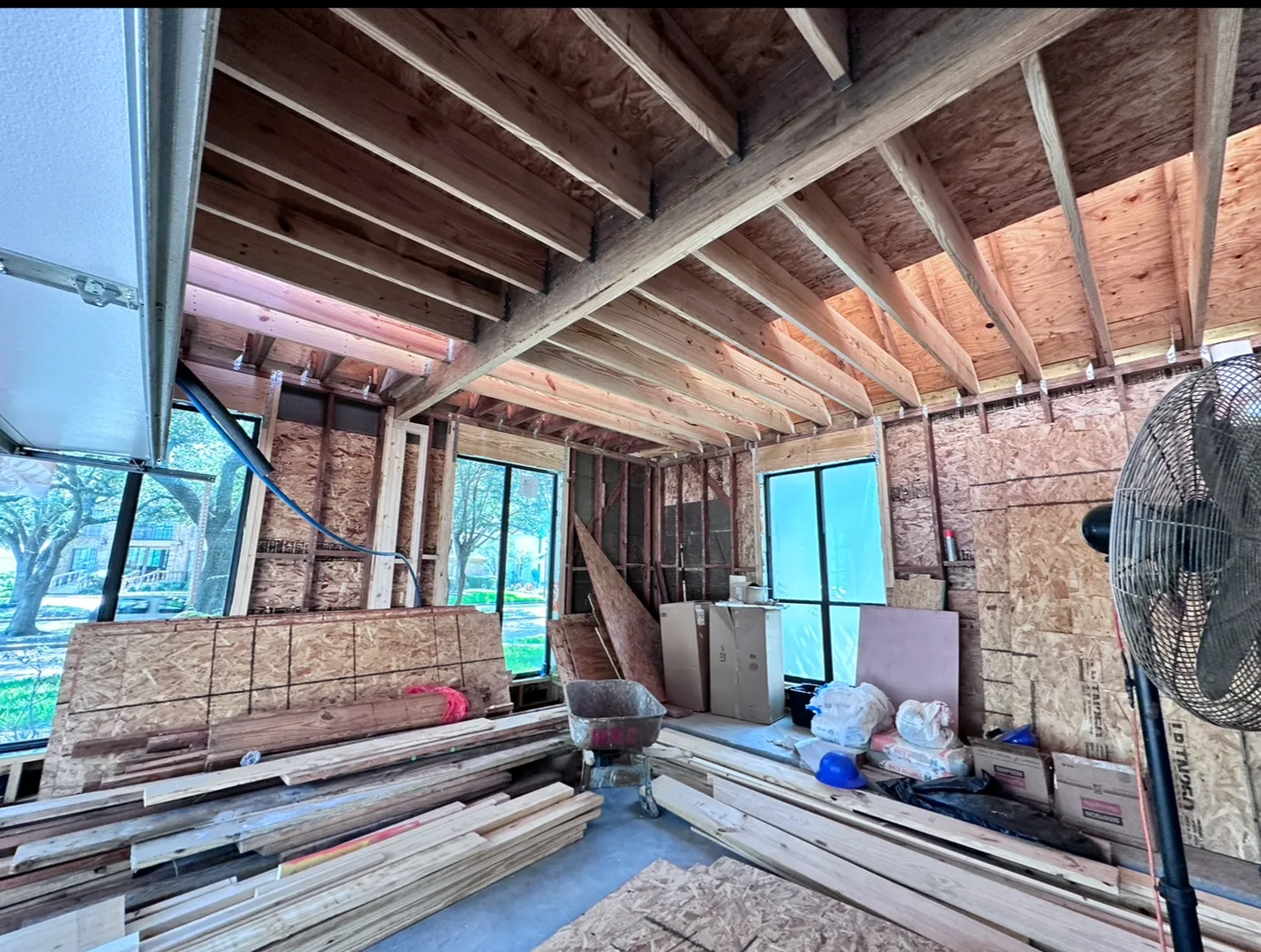 Exposed ceiling joists and wall framing during a Houston interior renovation