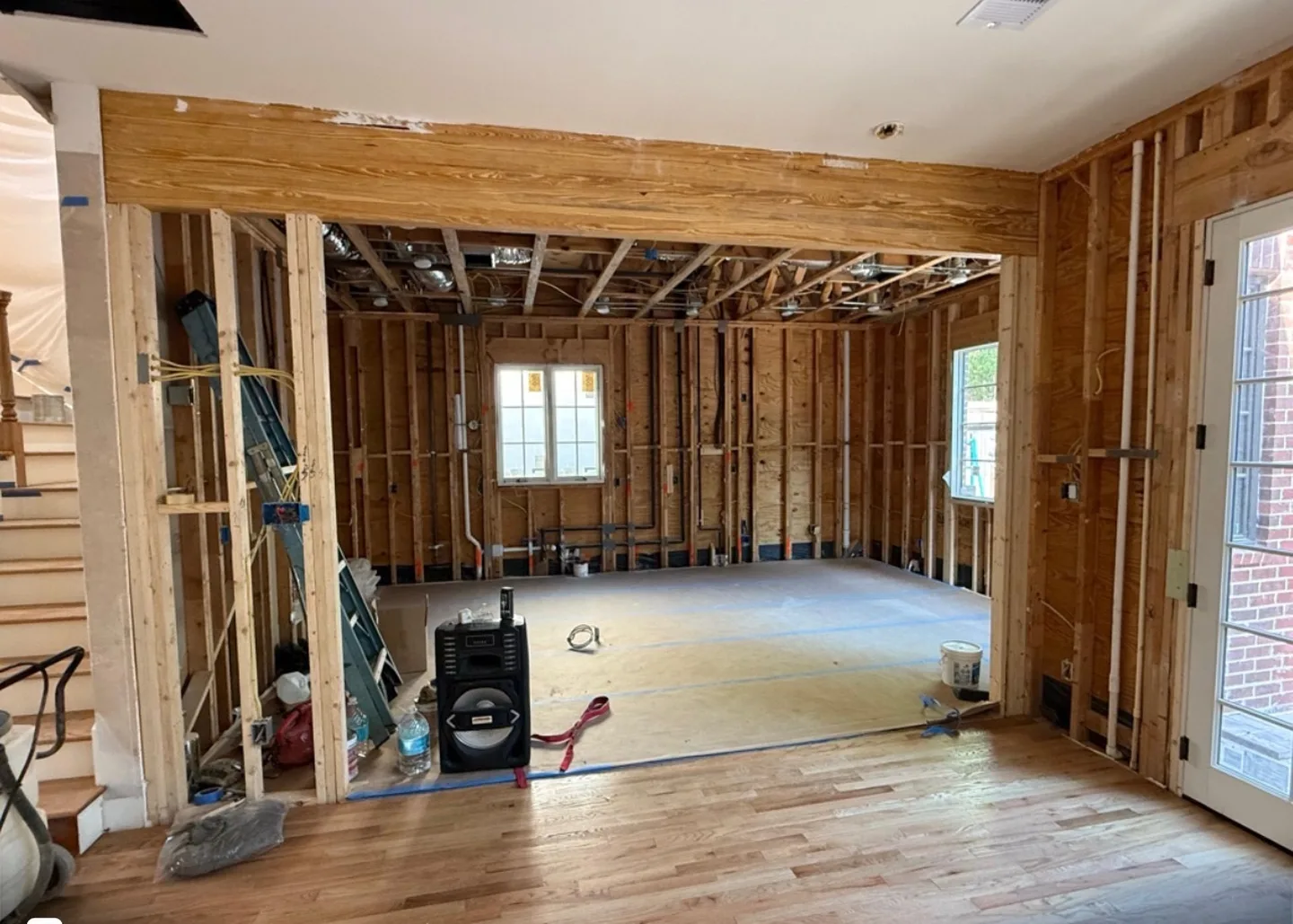 Interior framing, wiring and hardwood flooring during a Houston home renovation