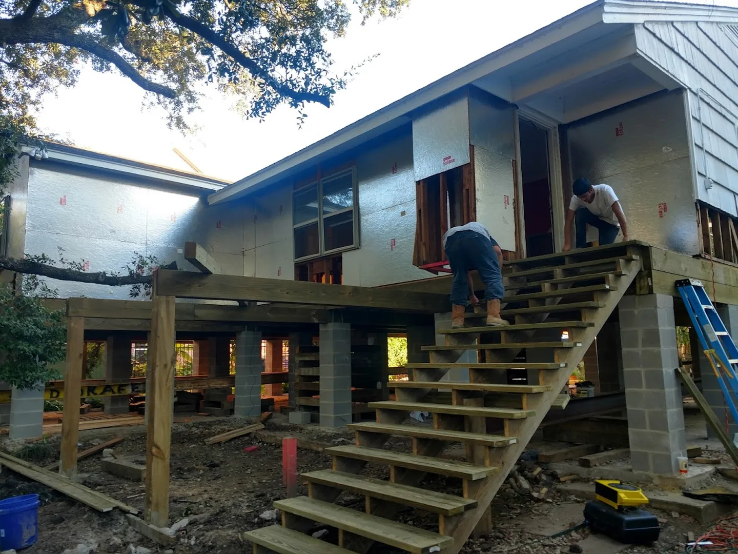 Covenant Project Solutions crew building exterior stairs on a raised Houston house renovation