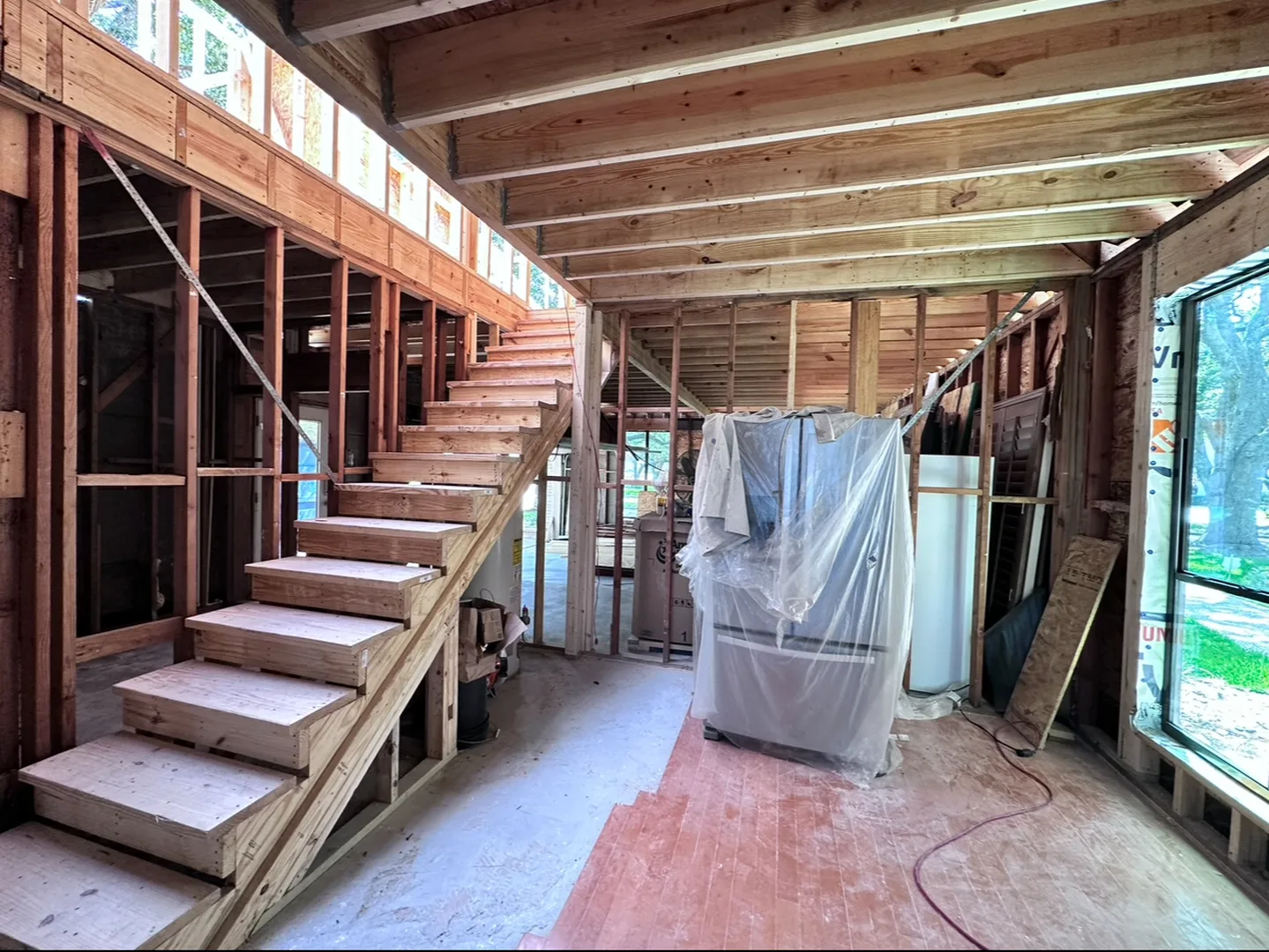 Framed staircase inside a Houston home renovation taken back to the studs